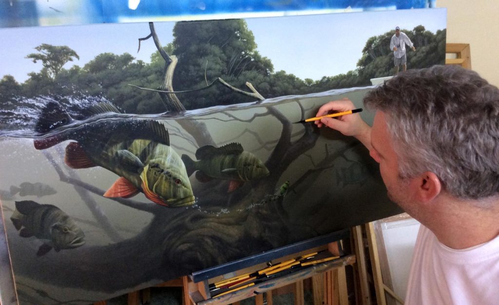 Craig painting a boat wrap.